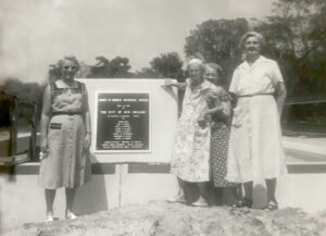 Members of James "Shavey" Hibben's family stand with the plaque that the city erected in 1958 in naming the Holiday Drive span the James W. Hibben Memorial Bridge. From left, his sister, Rita (Leblanc) Hibben, his great-grandmother Denia Dubret and, holding her from behind, his grandmother Wilhelmina Dubret Hibben. The identity of the woman on the right is unknown. (Photo courtesy of Eddie Hibben Jr.)
