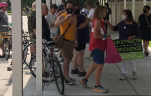 A leader of the Facebook group Bike Uneasy taunted Algiers residents at Alice M. Harte Charter School in August 2022, following the "Algiers Bike Bollard March." Upon hearing of the Algiers event, the east bank-based bicycling group traveled to the West Bank, rode past the marchers and awaited their arrival at the school. A Huntlee Village widow was provoked into reacting to being video recorded as she arrived. The video and memes depicting the woman appeared on Bike Uneasy's Facebook page soon after. They were later removed.